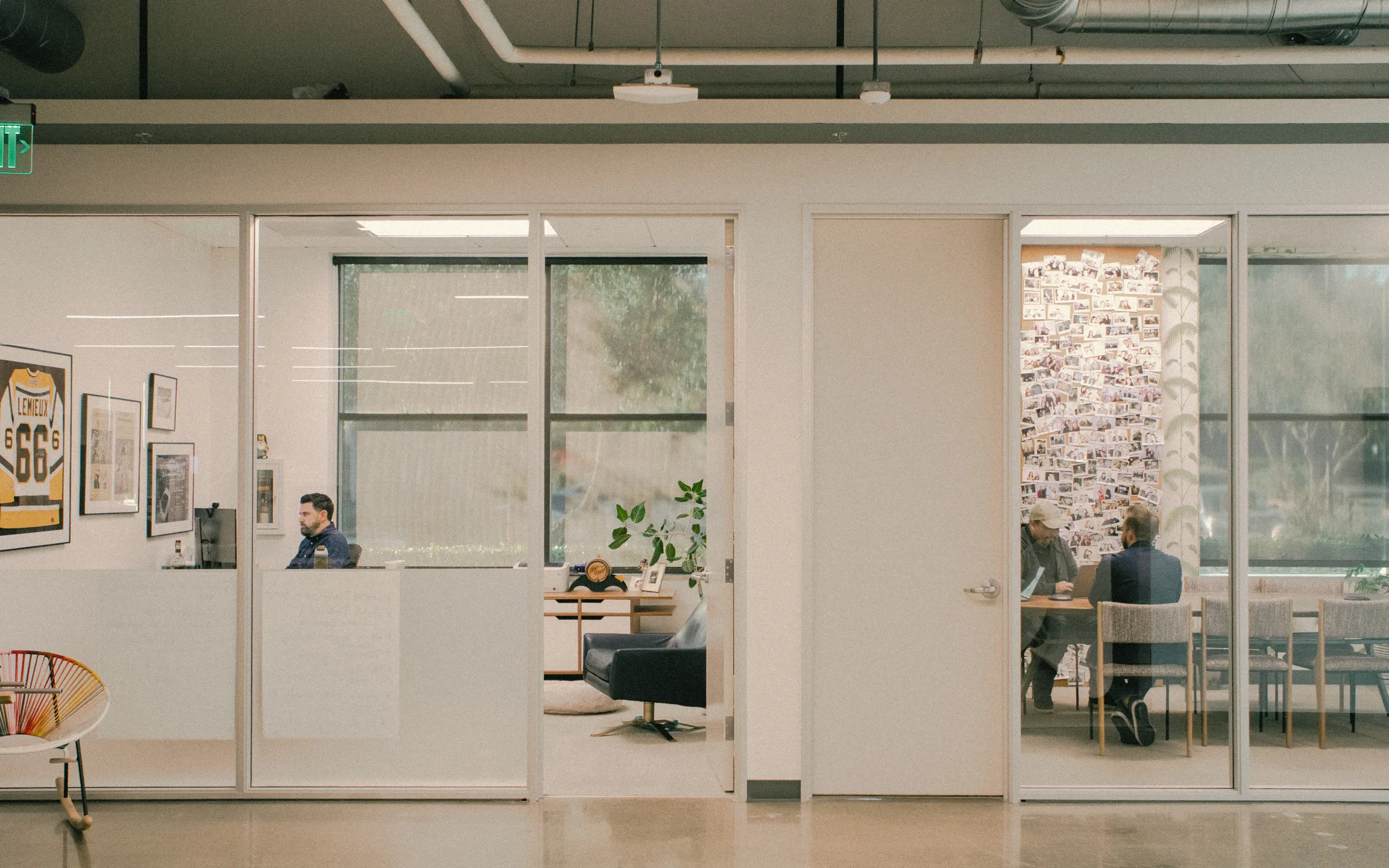 office view of the Dallas office with 1 room and multiple people in a meeting