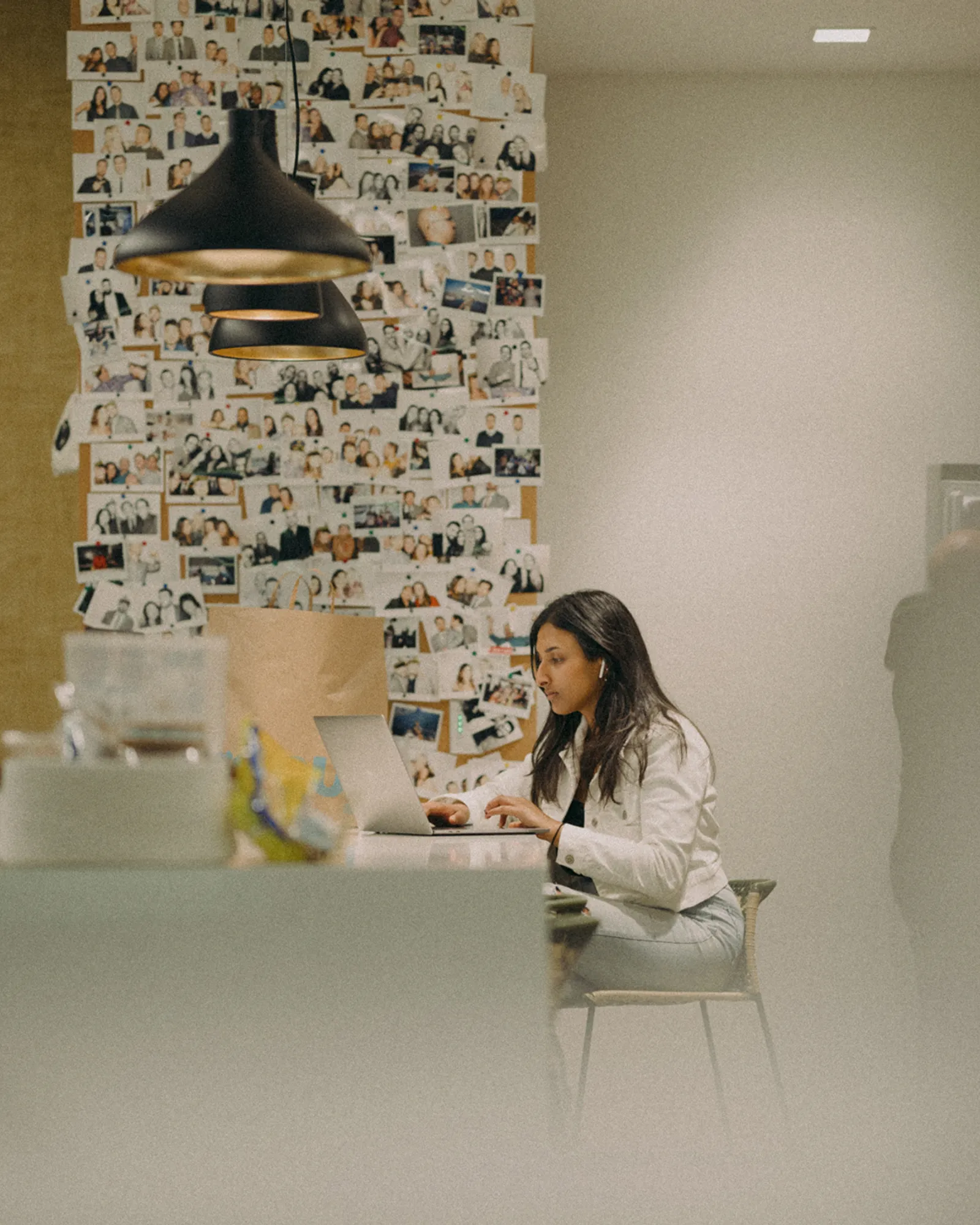 a designer focusing on a laptop in the aliso viejo office, pondering about the next big project