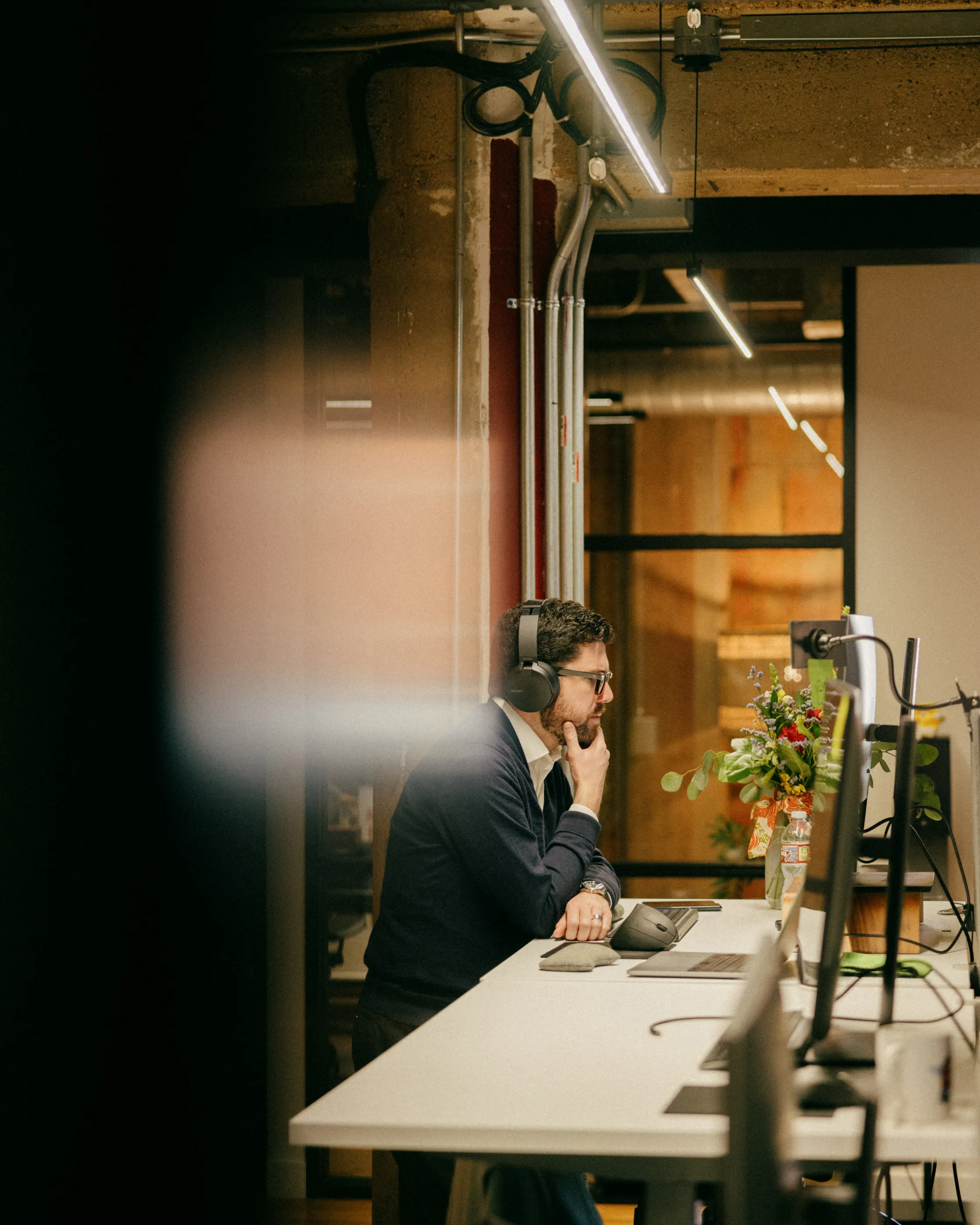 dallas office view of a man sitting at a desk looking at a computer screen
